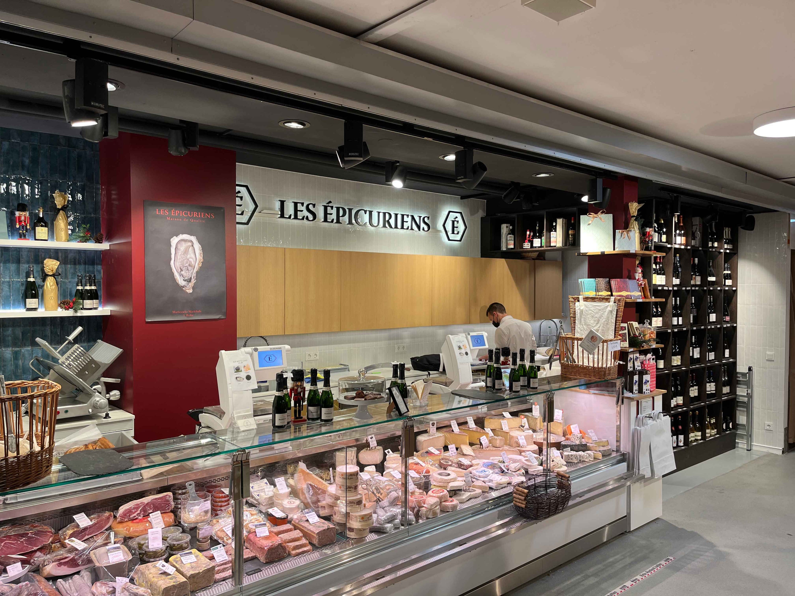 Innenansicht des Ladens Les Épicuriens mit Käse- und Frischetheke in der Markeineke Markthalle in Berlin Kreuzberg